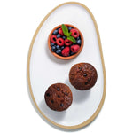 Delicious blueberry bran muffins made with best quality, organic flour and served with fresh berries and mint on a ceramic plate hand made by Julie York, local artist from Vancouver, BC. 