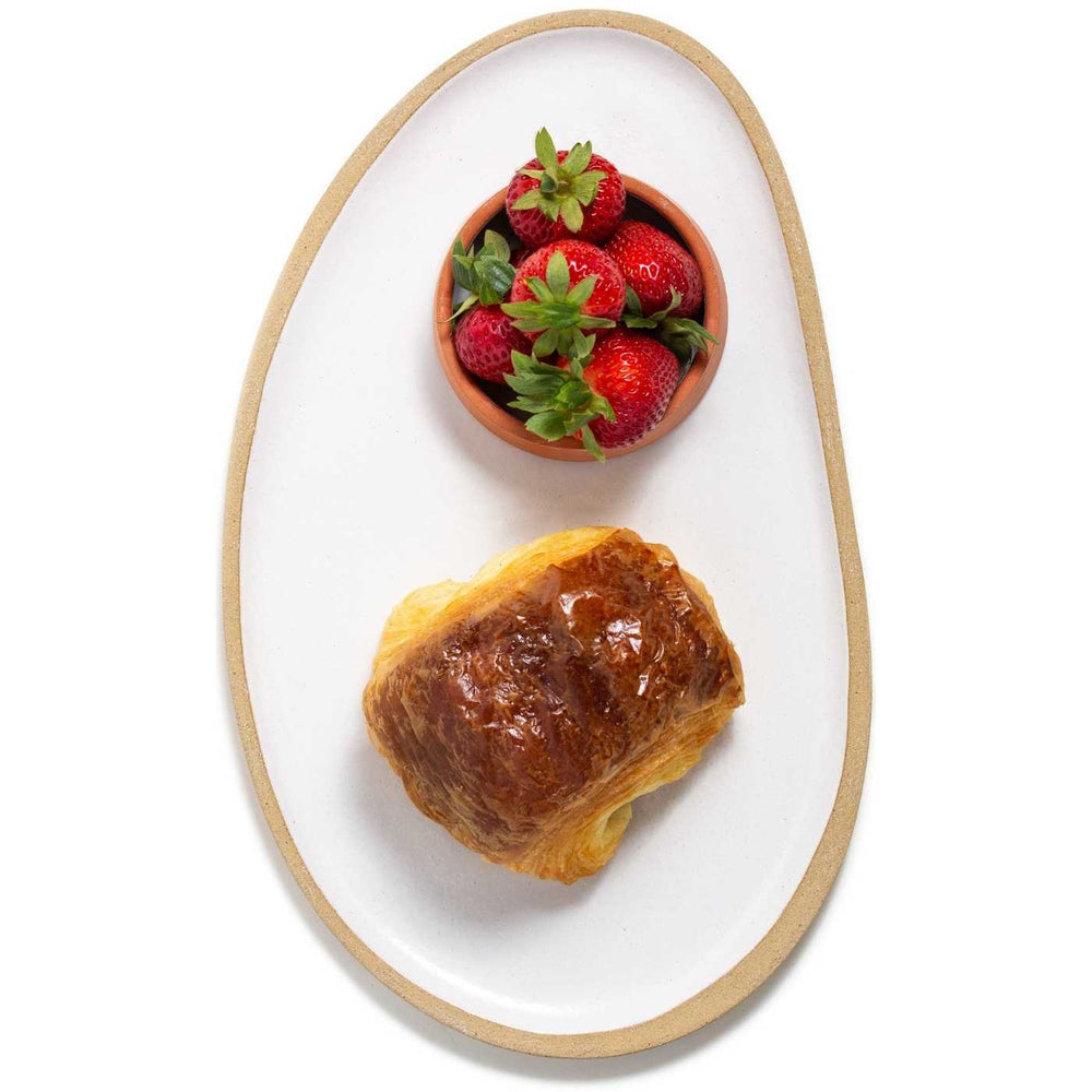 Best Pain au chocolat made with organic, best quality flour and belgian chocolate served with fresh strawberries on a hand made ceramic oval plate by Julie York, local artist from Vancouver, BC. 